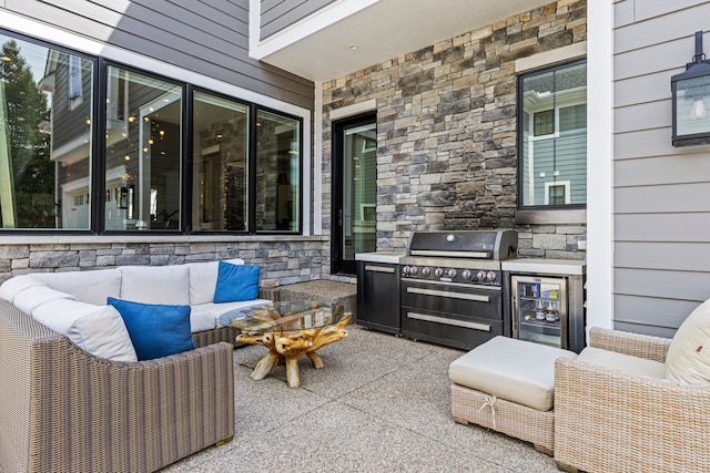 view of patio featuring beverage cooler, area for grilling, an outdoor hangout area, and an outdoor kitchen