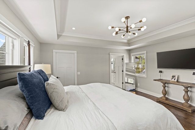 bedroom with wood finished floors, a chandelier, baseboards, a tray ceiling, and crown molding
