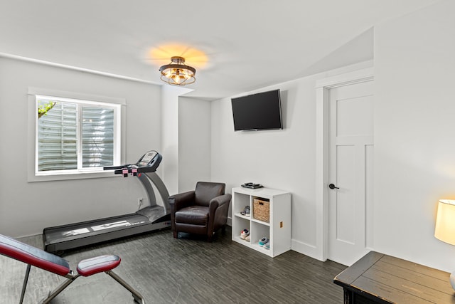 workout room with baseboards and dark wood-style flooring