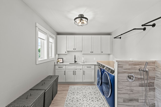 1486 Cedar Dr, Birmingham, MI 48009 - clothes washing area with washer and clothes dryer, cabinet space, light wood-style floors, and bar area