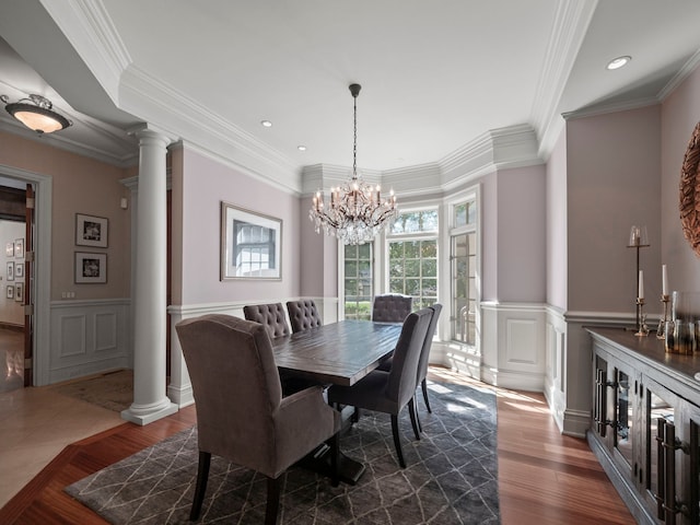 3418 Westchester Rd, Bloomfield Hills, MI 48304 - dining space with decorative columns, a wainscoted wall, dark wood-type flooring, crown molding, and a chandelier