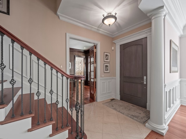 3418 Westchester Rd, Bloomfield Hills, MI 48304 - foyer featuring a decorative wall, ornamental molding, a wainscoted wall, tile patterned flooring, and stairs