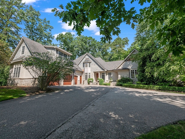 3418 Westchester Rd, Bloomfield Hills, MI 48304 - shingle-style home featuring driveway, stone siding, and a garage