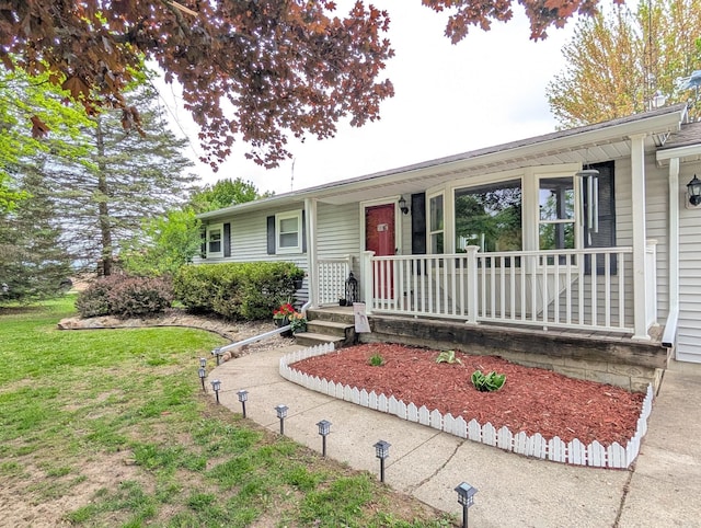 single story home with covered porch and a front lawn