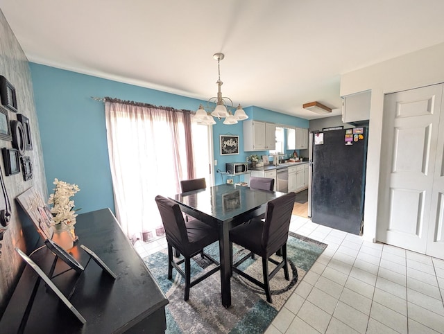 dining area featuring a chandelier and light tile patterned floors