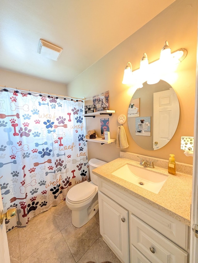 bathroom featuring tile patterned flooring, toilet, vanity, and a shower with curtain