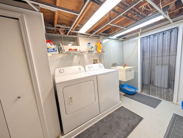 clothes washing area featuring independent washer and dryer and tile patterned floors
