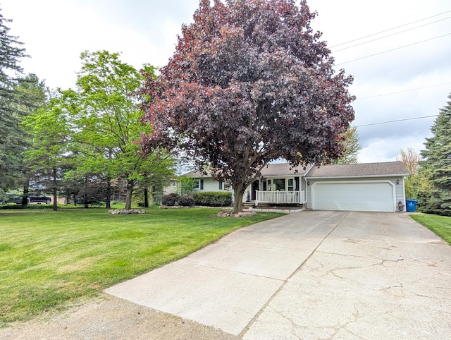 view of front of home with a garage, concrete driveway, a front yard, and a porch