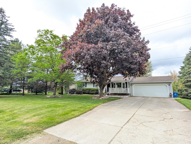 view of front of property featuring an attached garage, a front yard, driveway, and covered porch