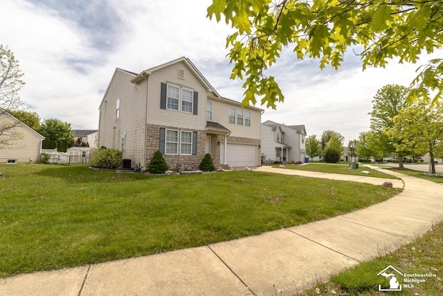 1786 Arbor Creek Dr, Monroe, MI 48162 - view of front of property with stone siding, a garage, driveway, and a front yard