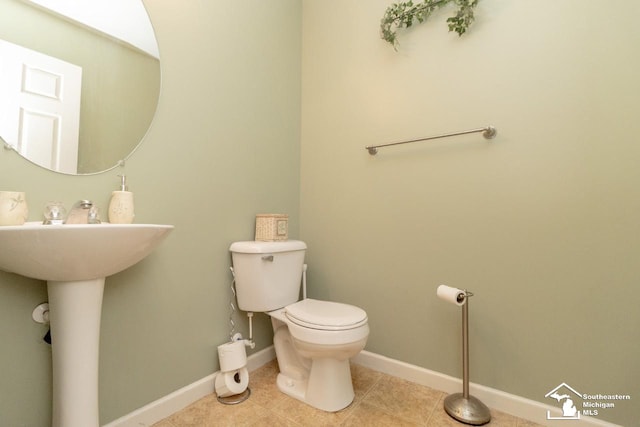 1786 Arbor Creek Dr, Monroe, MI 48162 - bathroom with toilet, baseboards, tile patterned floors, and a sink