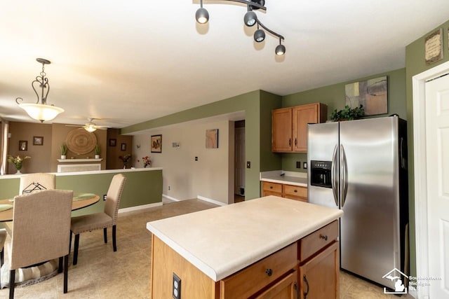 1786 Arbor Creek Dr, Monroe, MI 48162 - kitchen featuring stainless steel refrigerator with ice dispenser, a ceiling fan, brown cabinetry, open floor plan, and light countertops