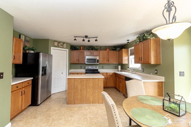 1786 Arbor Creek Dr, Monroe, MI 48162 - kitchen with stainless steel appliances, a sink, a center island, light countertops, and hanging light fixtures