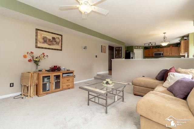 1786 Arbor Creek Dr, Monroe, MI 48162 - living area featuring light colored carpet, baseboards, and a ceiling fan