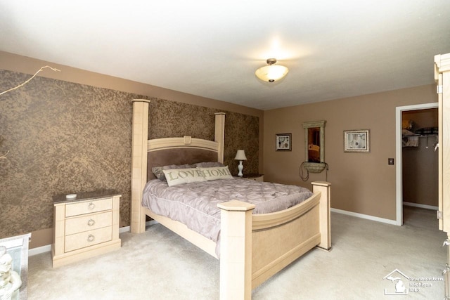 1786 Arbor Creek Dr, Monroe, MI 48162 - bedroom featuring light colored carpet, baseboards, and a walk in closet