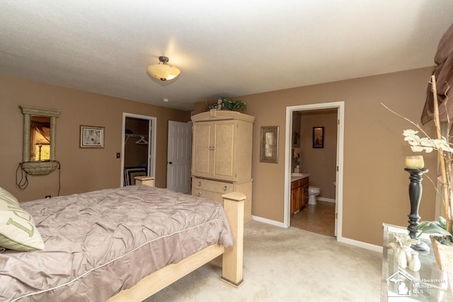 1786 Arbor Creek Dr, Monroe, MI 48162 - bedroom featuring light carpet, baseboards, ensuite bath, and a spacious closet