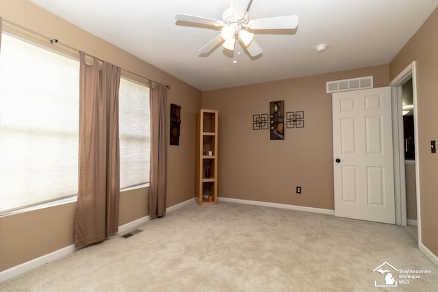 1786 Arbor Creek Dr, Monroe, MI 48162 - empty room with light colored carpet, ceiling fan, baseboards, and a smoke detector