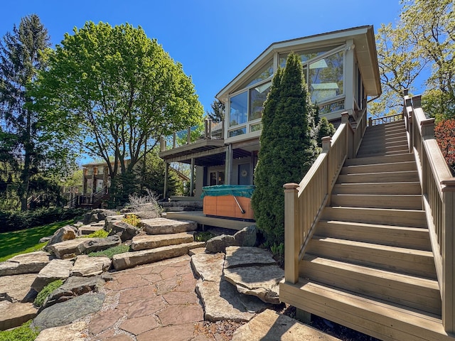 2660 Silverdown Ct, Waterford, MI 48328 - rear view of house with stairway, a hot tub, and a wooden deck