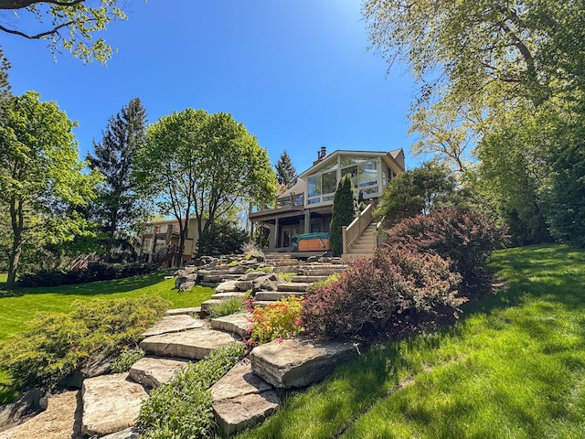 2660 Silverdown Ct, Waterford, MI 48328 - view of green lawn with stairway, a deck, and a sunroom