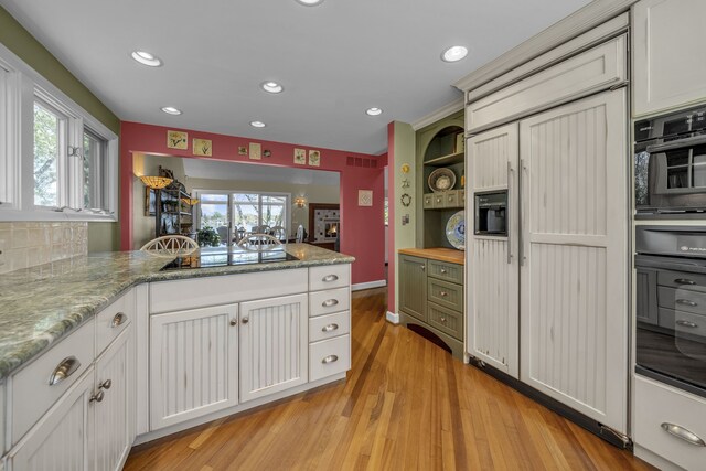 2660 Silverdown Ct, Waterford, MI 48328 - kitchen featuring black appliances, light wood-type flooring, a peninsula, recessed lighting, and white cabinets