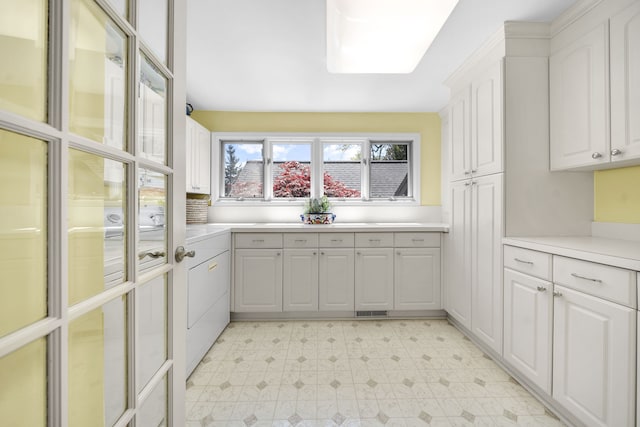 2660 Silverdown Ct, Waterford, MI 48328 - kitchen with light flooring, white cabinetry, and light countertops