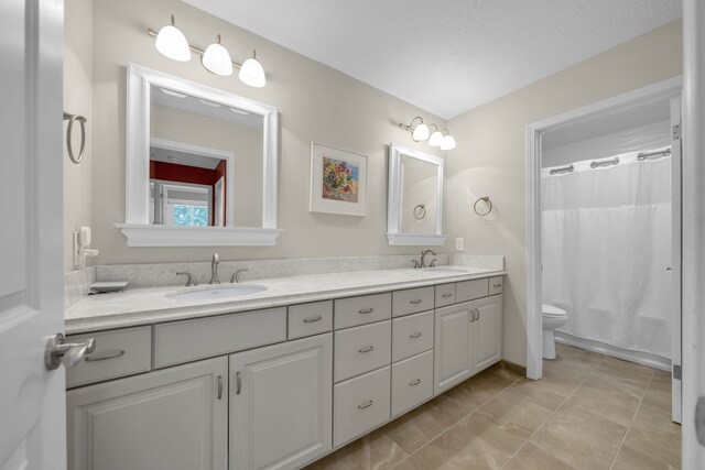 2660 Silverdown Ct, Waterford, MI 48328 - bathroom with toilet, double vanity, and a shower with shower curtain