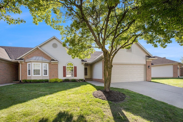 traditional-style home with brick siding, an attached garage, concrete driveway, and a front yard