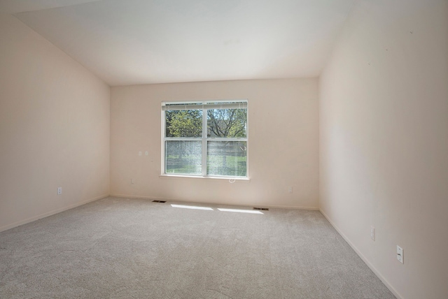 spare room featuring carpet floors and baseboards