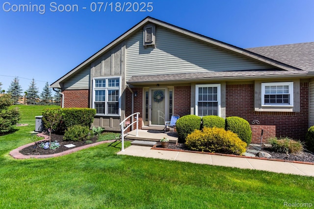 25380 Tara Ln, Flat Rock, MI 48134 - view of front of home with brick siding, a front yard, and roof with shingles