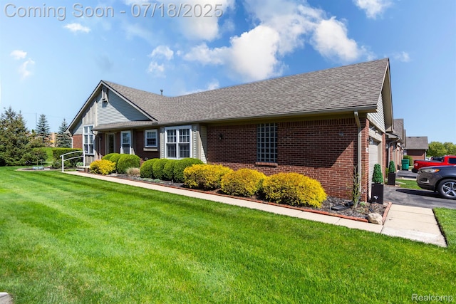 25380 Tara Ln, Flat Rock, MI 48134 - view of front of home with brick siding, a front lawn, roof with shingles, and an attached garage