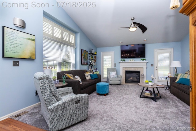 25380 Tara Ln, Flat Rock, MI 48134 - living area featuring a ceiling fan, a glass covered fireplace, lofted ceiling, and carpet flooring