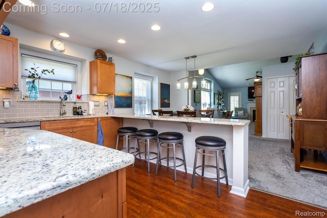 25380 Tara Ln, Flat Rock, MI 48134 - kitchen featuring a kitchen breakfast bar, healthy amount of natural light, recessed lighting, a peninsula, and decorative backsplash