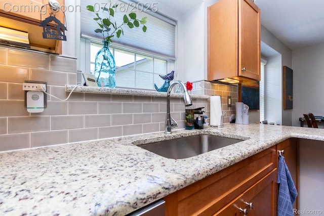 25380 Tara Ln, Flat Rock, MI 48134 - kitchen featuring decorative backsplash, light stone counters, and brown cabinets