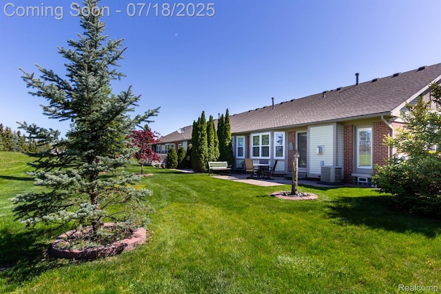 25380 Tara Ln, Flat Rock, MI 48134 - rear view of house featuring a patio area, brick siding, a yard, and a shingled roof
