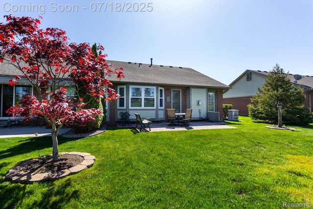 25380 Tara Ln, Flat Rock, MI 48134 - back of house with a patio, a yard, brick siding, and a shingled roof