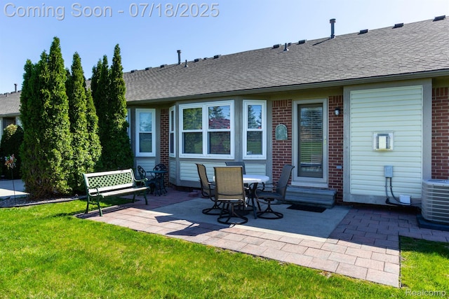 25380 Tara Ln, Flat Rock, MI 48134 - back of house featuring brick siding, a patio, roof with shingles, and a yard