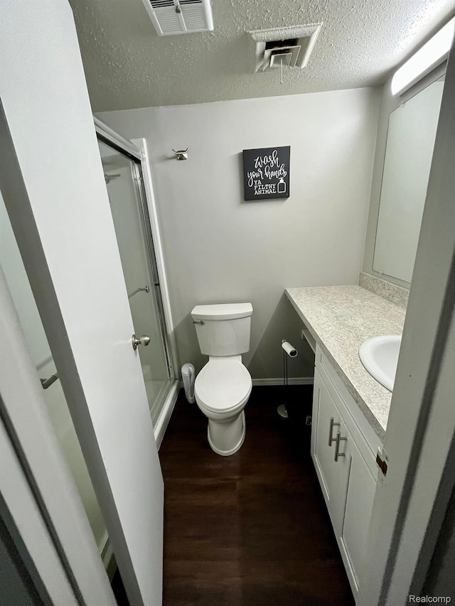 6210 Tennis Ct Unit D-11, Bay City, MI 48706 - full bath with wood finished floors, a stall shower, toilet, vanity, and a textured ceiling