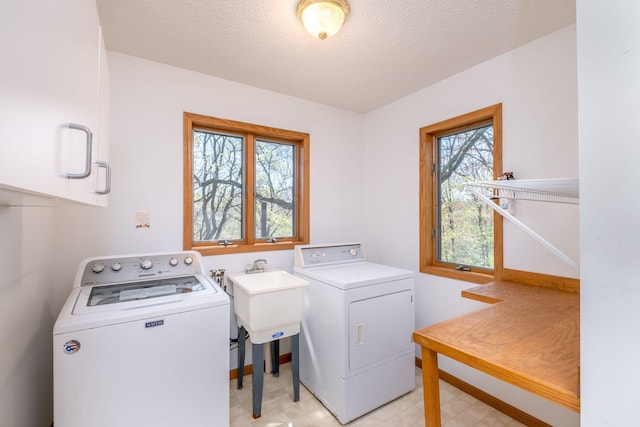 11021 Heather Ln, Canadian Lakes, MI 49346 - laundry room with cabinet space, washer and clothes dryer, baseboards, light floors, and a textured ceiling