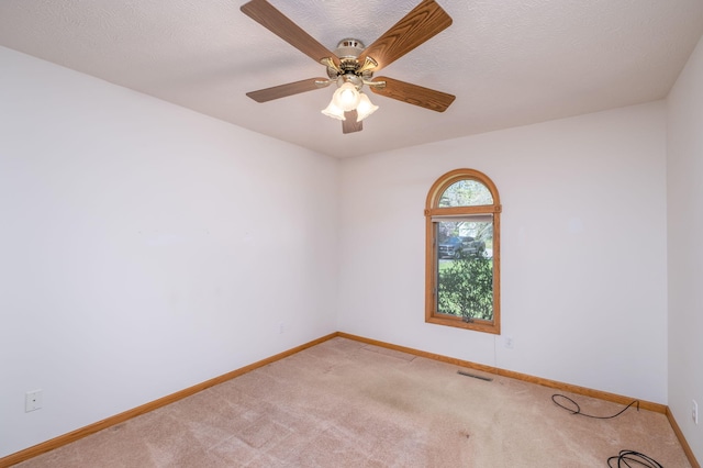 11021 Heather Ln, Canadian Lakes, MI 49346 - empty room featuring baseboards, light colored carpet, and a ceiling fan