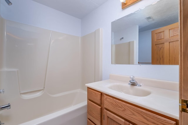 11021 Heather Ln, Canadian Lakes, MI 49346 - bathroom with tub / shower combination and vanity