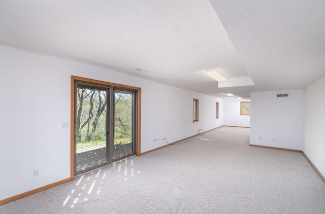11021 Heather Ln, Canadian Lakes, MI 49346 - empty room featuring baseboards, plenty of natural light, and carpet
