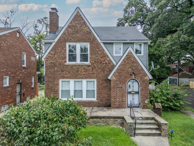 18600 Monica St, Detroit, MI 48221 - tudor home featuring a chimney, brick siding, and a shingled roof