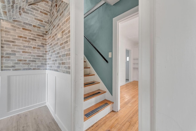 18600 Monica St, Detroit, MI 48221 - stairway with wood-type flooring, wainscoting, and brick wall