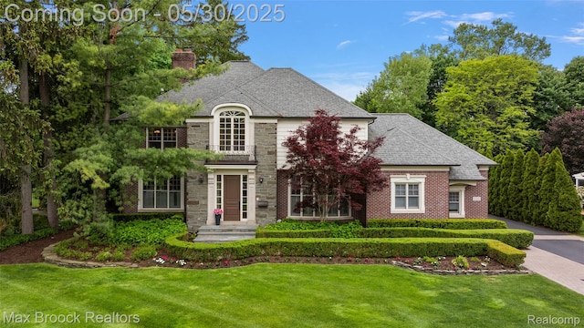 222 Arlington St, Birmingham, MI 48009 - french country home with a chimney, a front lawn, brick siding, and roof with shingles