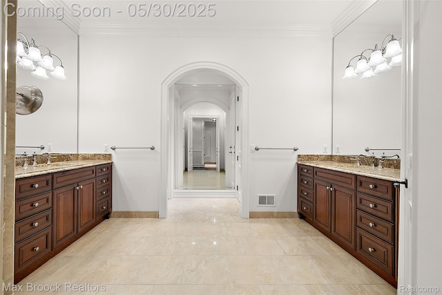 222 Arlington St, Birmingham, MI 48009 - full bathroom with crown molding, two vanities, and baseboards