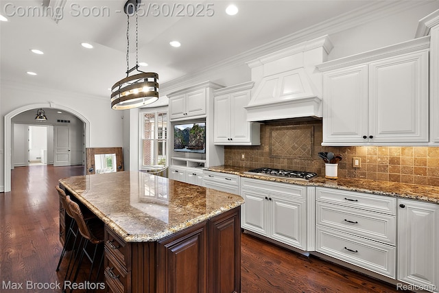 222 Arlington St, Birmingham, MI 48009 - kitchen featuring stainless steel gas cooktop, crown molding, recessed lighting, decorative backsplash, and light stone countertops