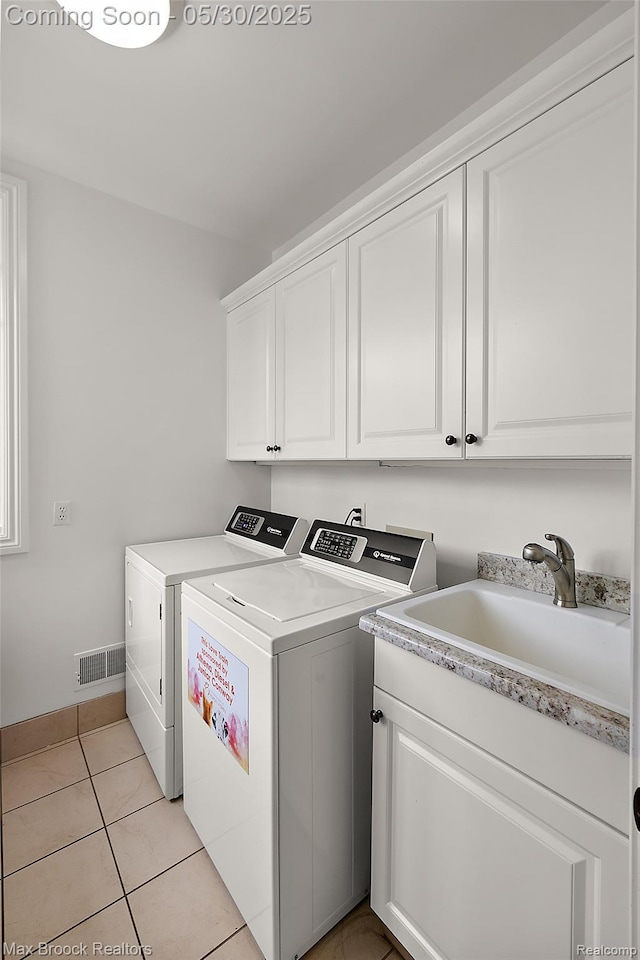 222 Arlington St, Birmingham, MI 48009 - washroom featuring washer and dryer, cabinet space, and light tile patterned flooring