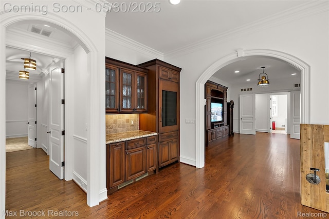222 Arlington St, Birmingham, MI 48009 - hallway featuring ornamental molding, dark wood-style floors, arched walkways, recessed lighting, and baseboards