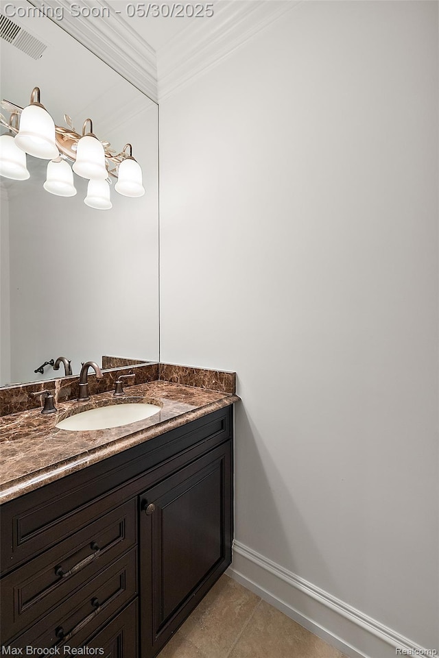 222 Arlington St, Birmingham, MI 48009 - bathroom with vanity, tile patterned flooring, ornamental molding, and baseboards
