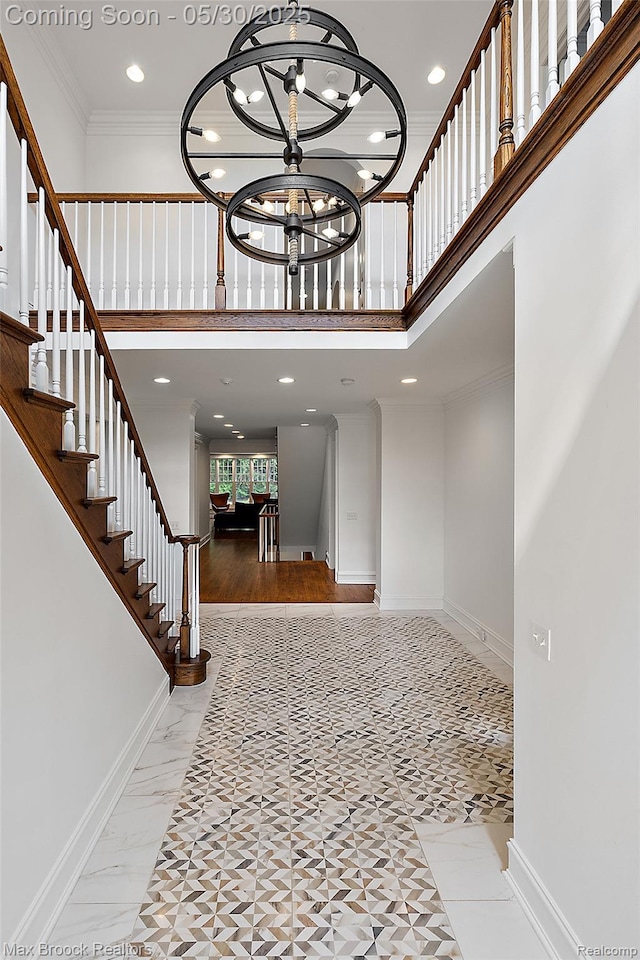 222 Arlington St, Birmingham, MI 48009 - foyer entrance featuring ornamental molding, a high ceiling, a chandelier, recessed lighting, and baseboards
